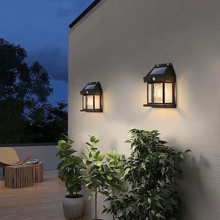 Pair of solar outdoor wall lanterns on exterior wall