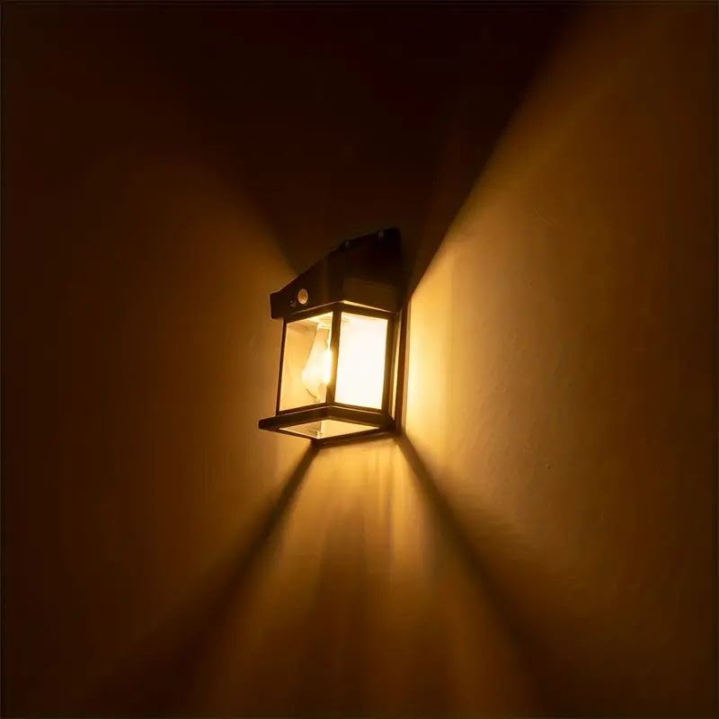 Solar outdoor wall lantern emitting warm ambient light